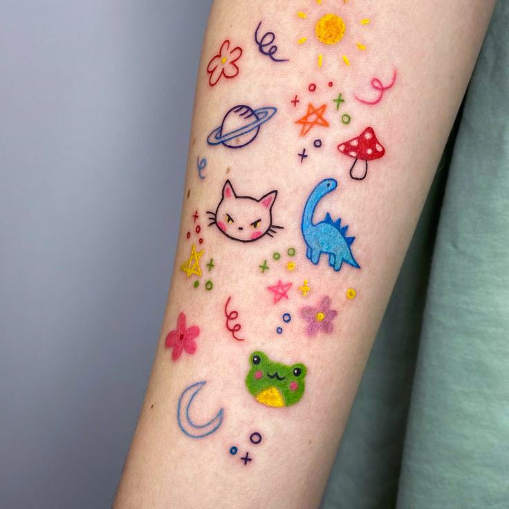 Colorful whimsical tattoo on arm with cat, dinosaur, frog, and celestial designs. Playful, vibrant body art.