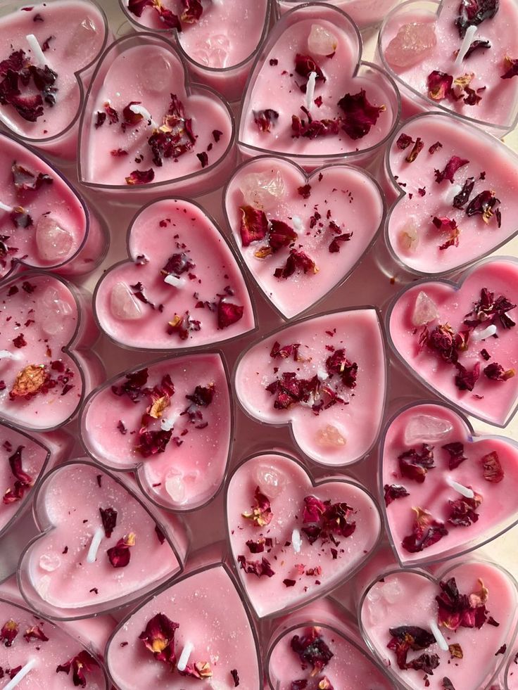 Heart-shaped pink candles adorned with dried rose petals, creating a romantic and soothing ambiance.