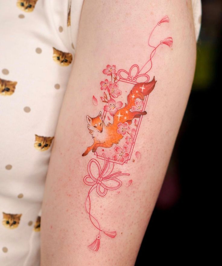 Colorful fox tattoo with floral accents on an arm, featuring cherry blossoms and elegant red line art.