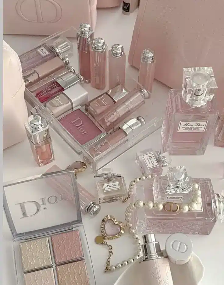 Dior 💓 Luxurious pink Dior cosmetics and perfumes neatly arranged, featuring lipsticks, eyeshadows, and elegant accessories. | Sky Rye Design Luxurious pink Dior cosmetics and perfumes neatly arranged, featuring lipsticks, eyeshadows, and elegant accessories.