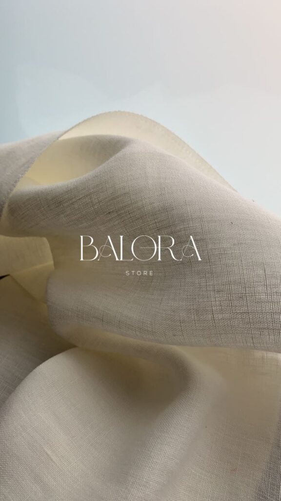 Smooth beige fabric with elegant drape, featuring the Balora Store logo.