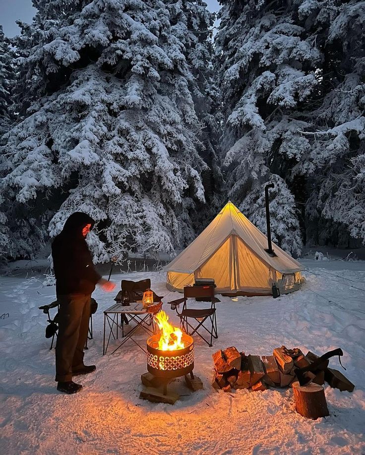 Cozy winter camping scene with a glowing tent and campfire in a snowy forest, creating a warm and inviting atmosphere.