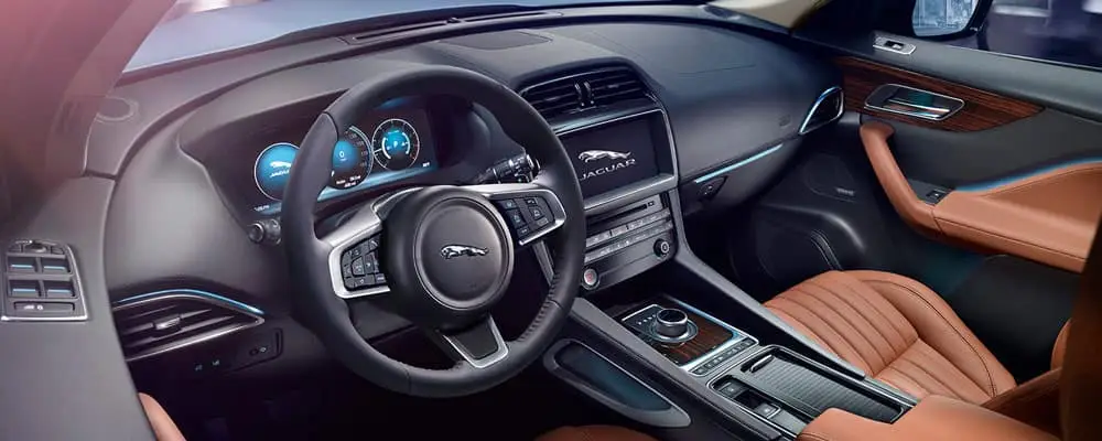 Luxury car interior with leather seats, elegant dashboard, and modern steering wheel design.