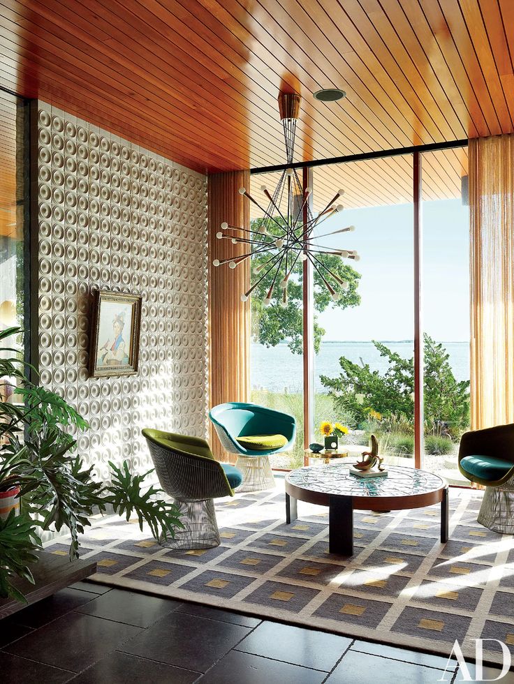 Mid-century modern living room with lake view, retro furniture, wood ceiling, and geometric decor. Cozy and stylish interior.