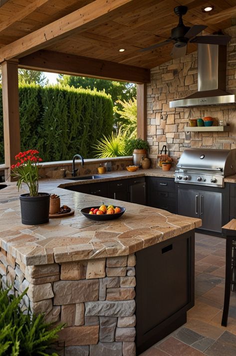 Outdoor kitchen with stone countertops, stainless grill, and potted plants, set under a wooden pergola with lush greenery.