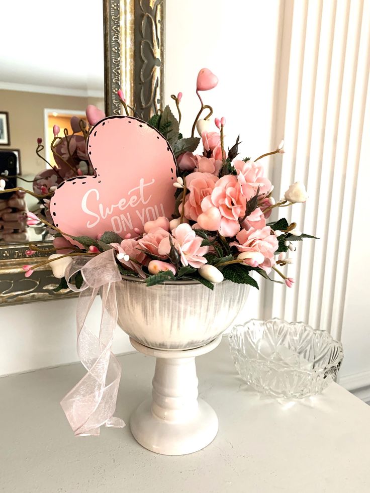 Elegant pink floral arrangement in a white vase with heart decoration and Sweet on You message. Perfect for Valentine's.