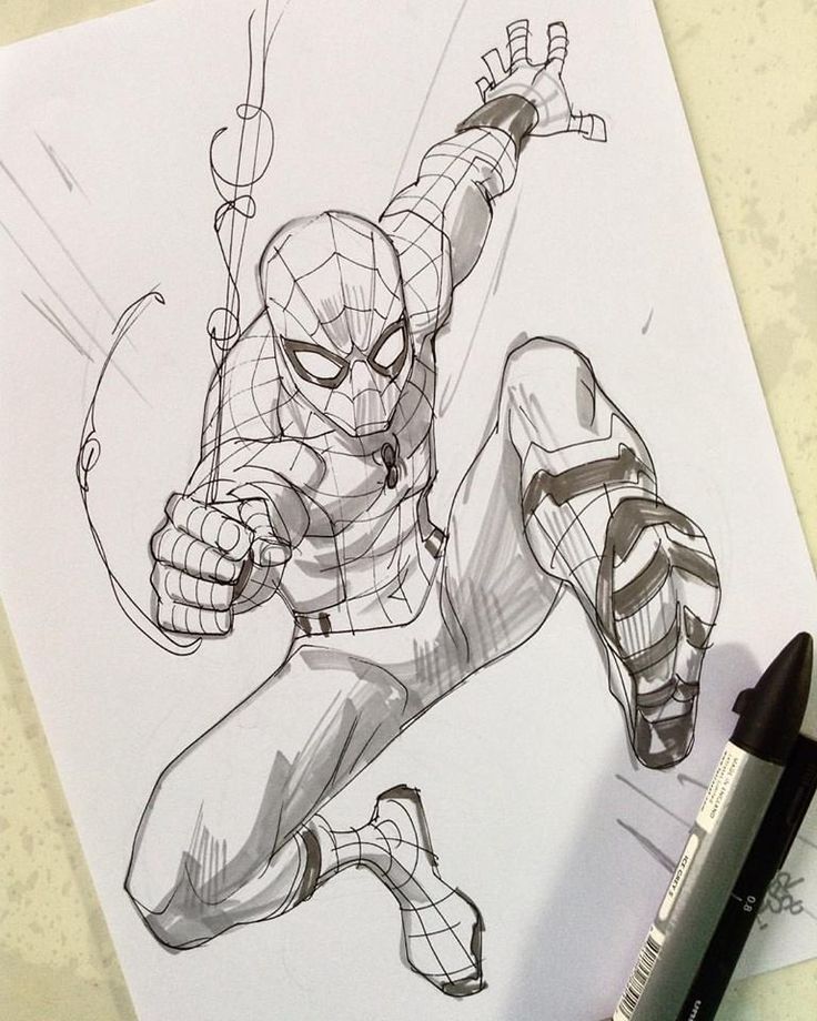 Comic-style sketch of a superhero in action pose, with a marker pen beside the drawing.