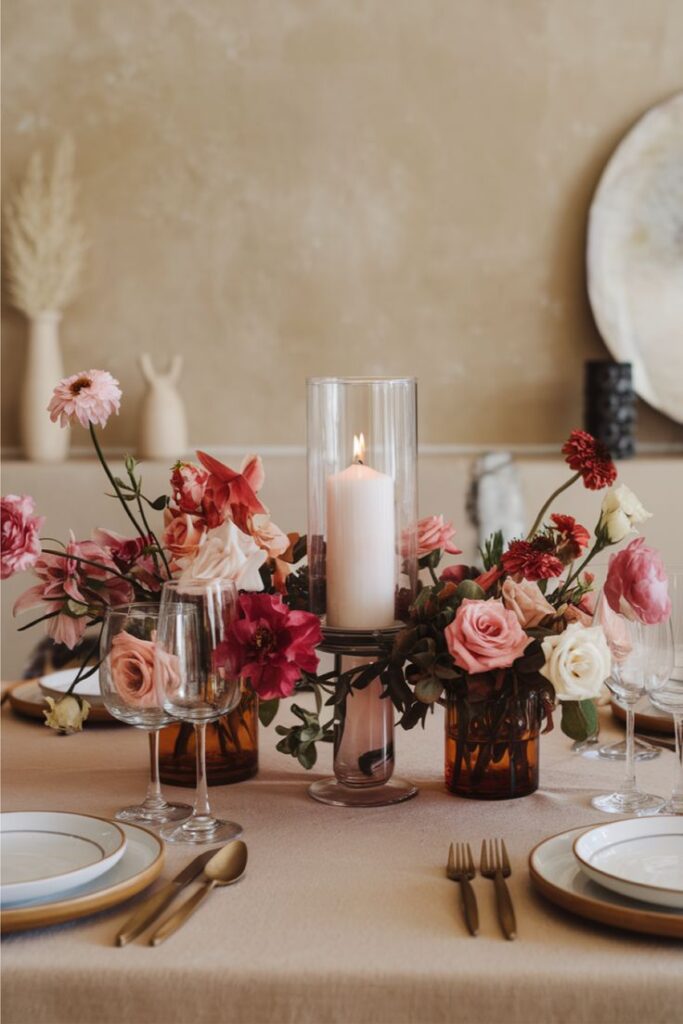 Elegant table setting with flowers and candle centerpiece, ideal for romantic or festive dining occasions.