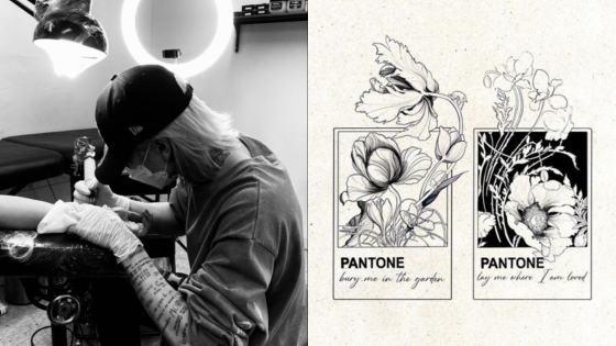 Tattoo artist working on an arm; floral black and white designs labeled Pantone on display.