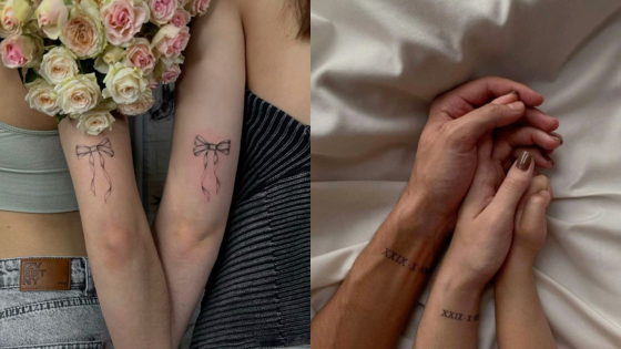 Two people showing matching bow and date tattoos on their arms, symbolizing love and connection.