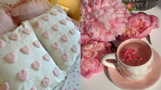 Pink heart-patterned pillows and a floral teacup with peonies on a white surface for a cozy, romantic vibe.