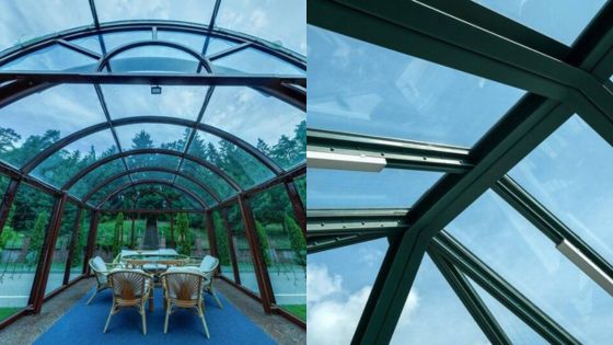 Glass-enclosed dining area with outdoor views and blue sky, featuring modern architectural design.