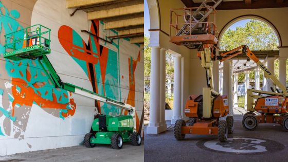 Boom lifts in action: painting a mural and working under an archway. Efficient equipment for high-reach tasks.