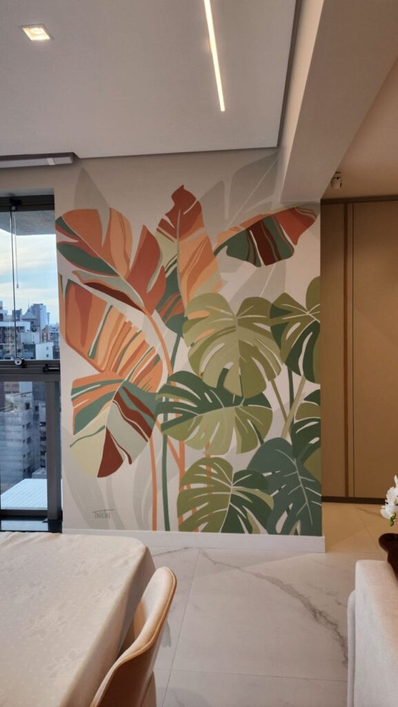 Colorful tropical leaf mural decorates a modern dining room wall.