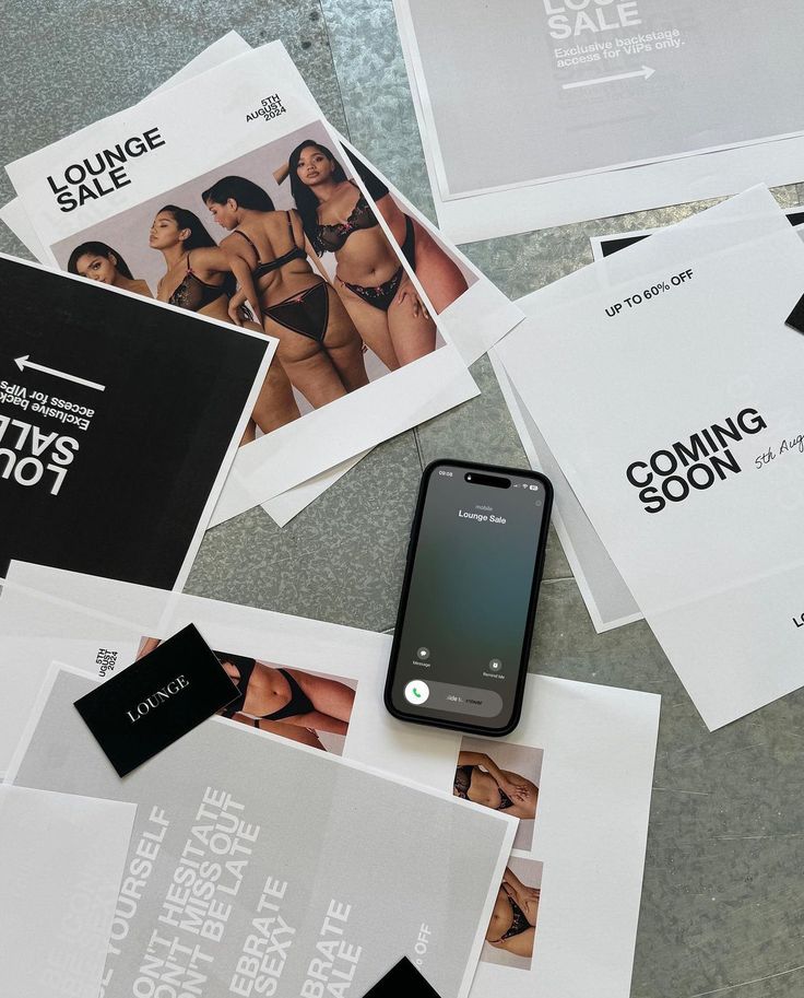 Lounge sale preparation with flyers, smartphone, and lingerie images on a table. Sale date: 5th August 2023.