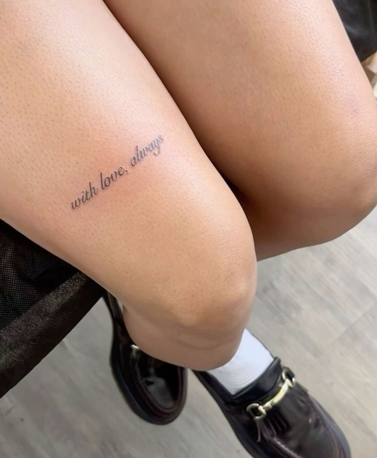 Tattoo on thigh reading with love, always with black shoes and white socks. Minimalistic script tattoo design.