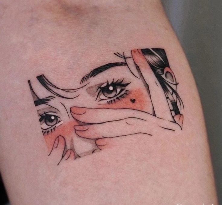 Tattoo of a woman's face with expressive eyes, framed by hands and accented with blush and a small heart on the cheek.