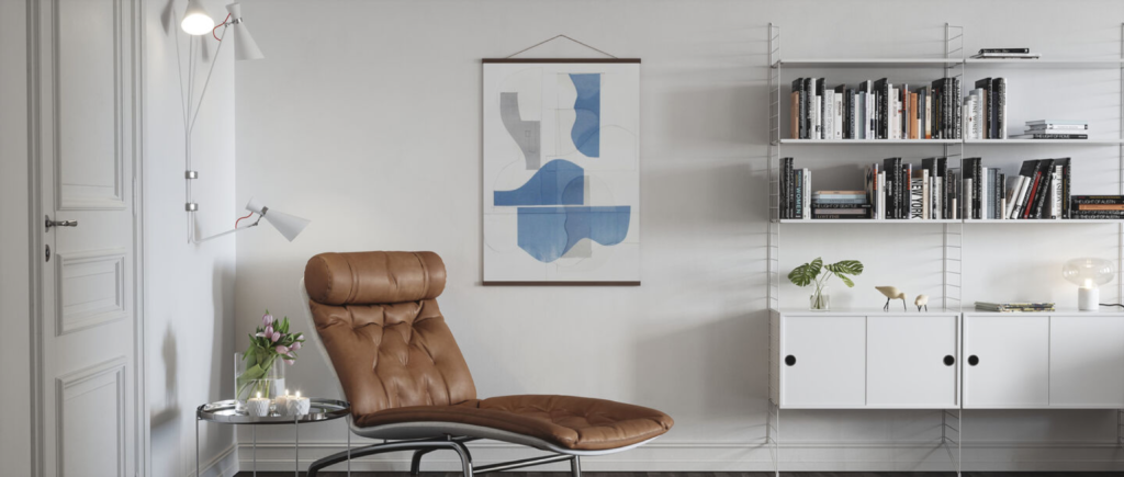 Modern living room with brown leather chair, abstract blue art, wall-mounted bookshelf, and minimalist decor.