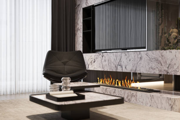 Modern living room with marble fireplace, flat-screen TV, and sleek black chair. Contemporary interior design setup.