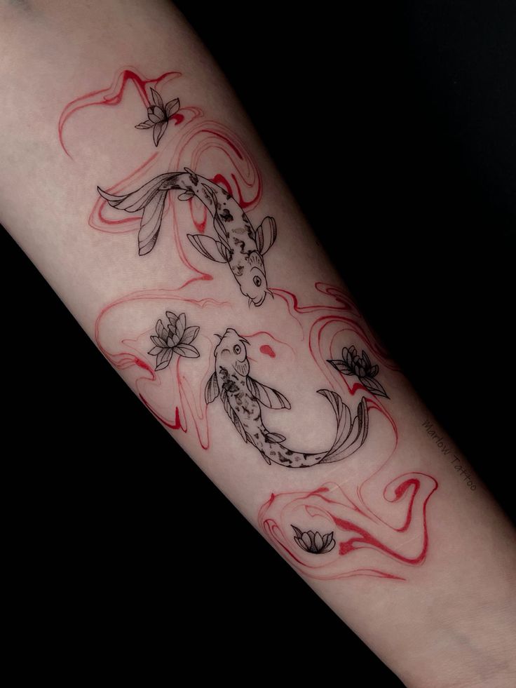 Koi fish tattoo with red swirls and lotus flowers on forearm, intricate design with black and red ink.