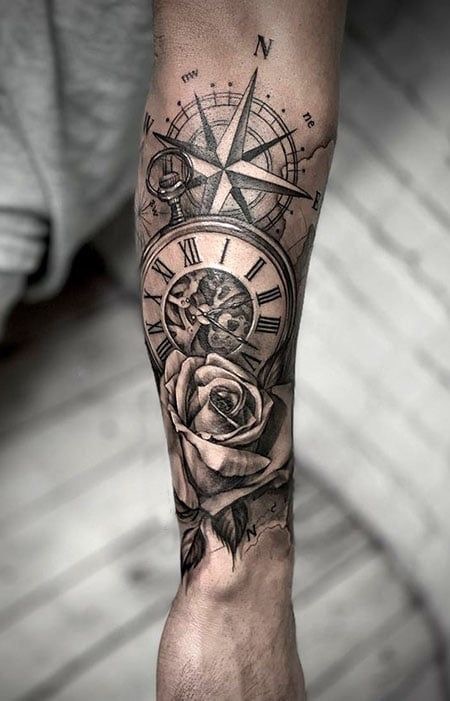 Tattoo design featuring a compass, clock with Roman numerals, and a realistic rose on a forearm.