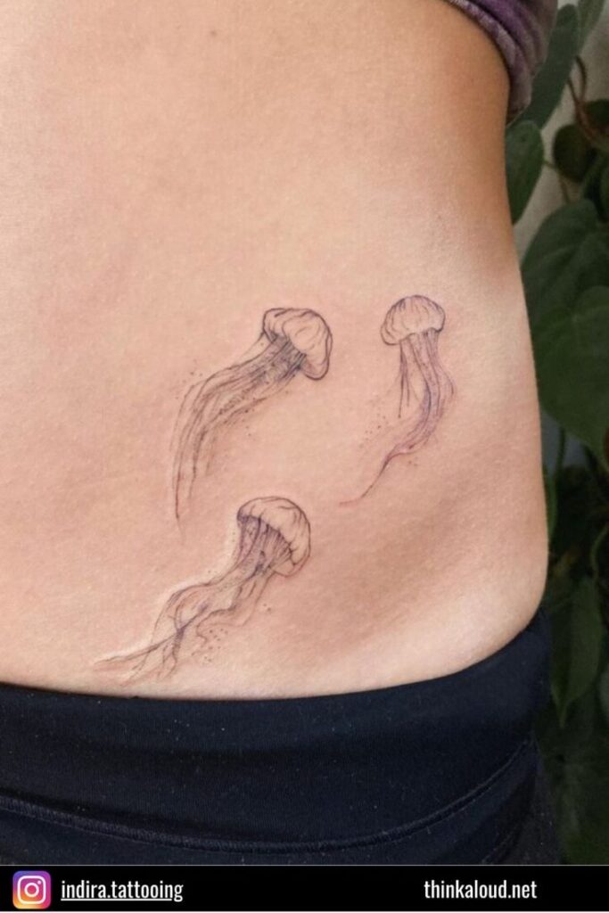 Minimalist jellyfish tattoo design on side of body, showcasing delicate lines and ocean theme.