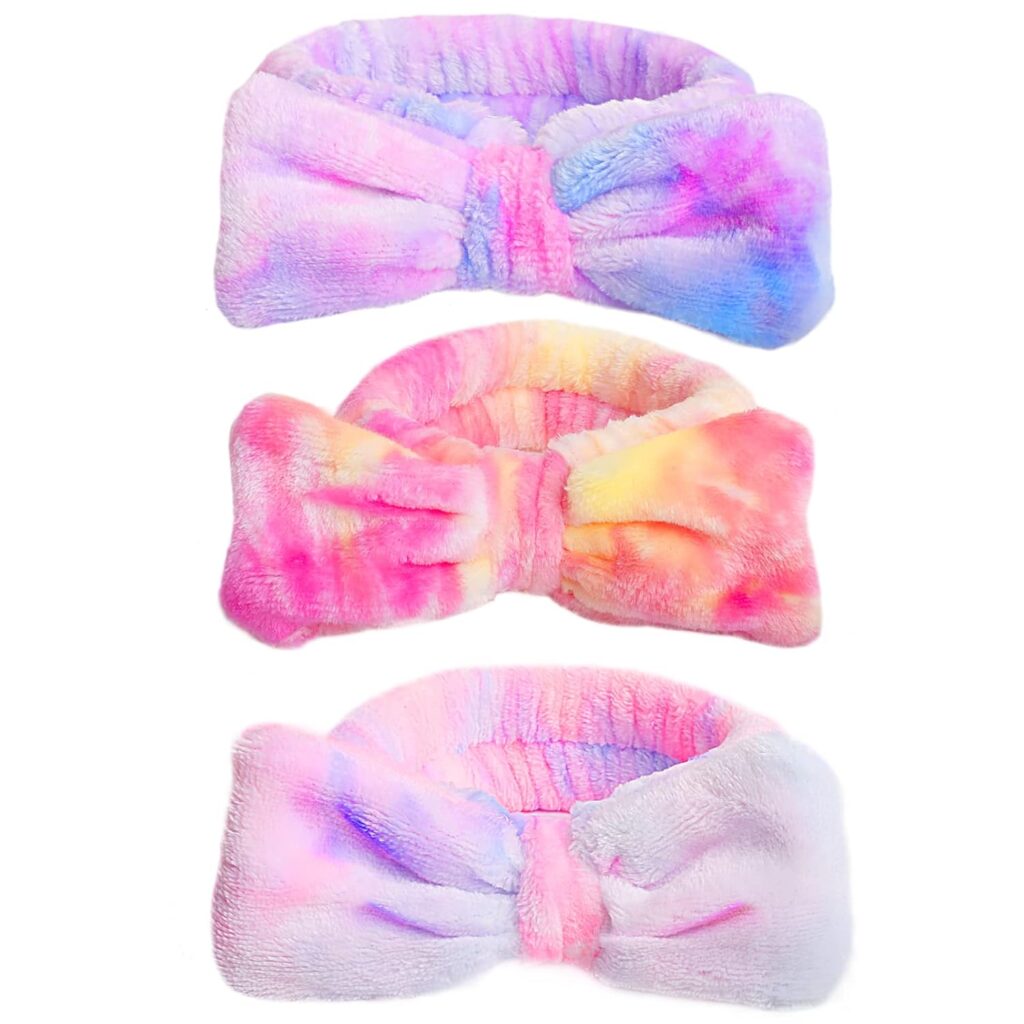 Colorful plush headbands with bow design in pastel tie-dye patterns, perfect for skincare routines and beauty rituals.