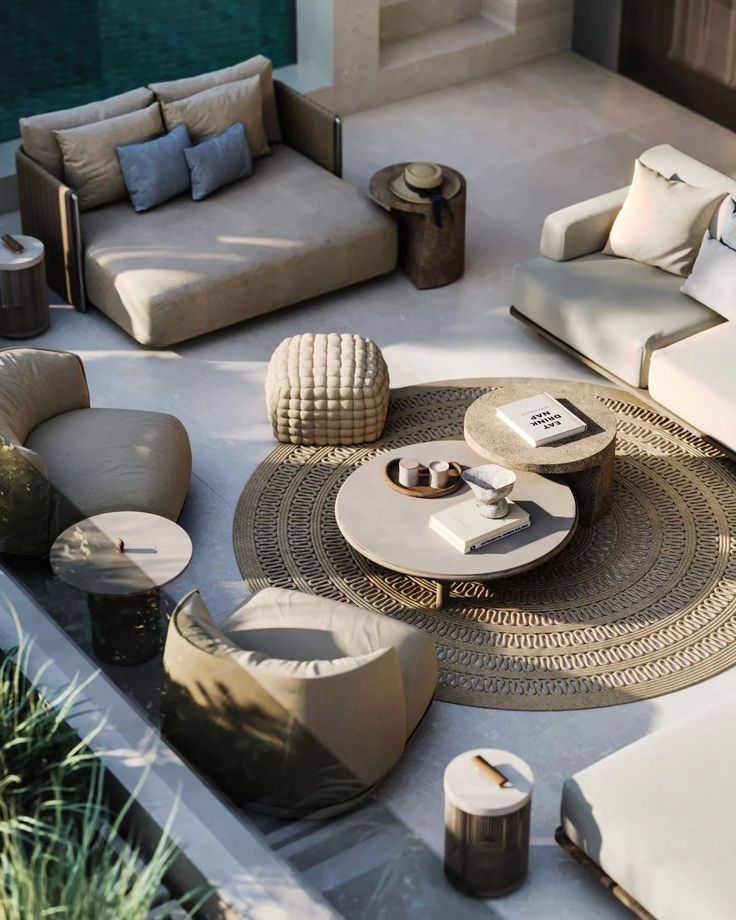 Luxurious outdoor patio seating with stylish furniture, circular rug, and coffee table set for relaxation.