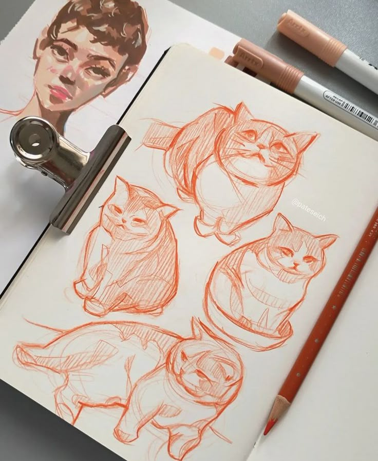 Sketchbook with cat drawings and a portrait. Art supplies include pencils and markers on the desk.