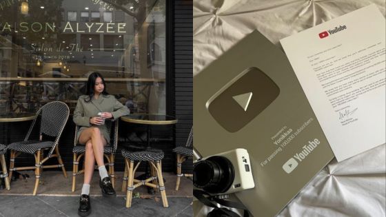 Woman sitting outside café; YouTube Silver Play Button and camera on table.