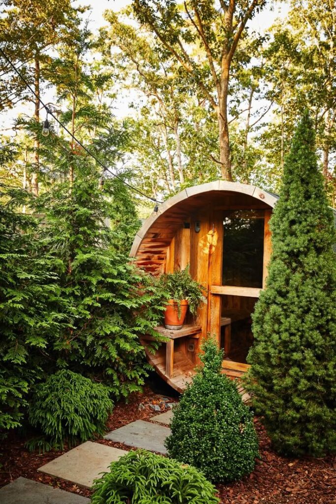 Cozy wooden garden cabin surrounded by lush greenery and trees, perfect for a tranquil escape.