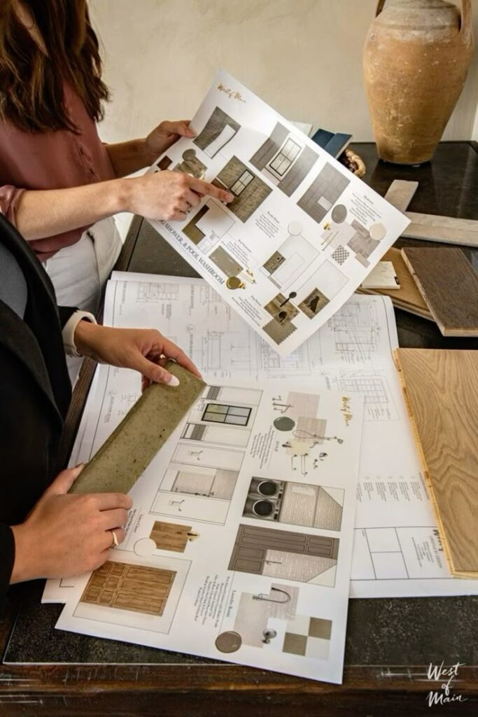 Interior designers reviewing mood boards and materials for a home project with detailed sketches and samples.