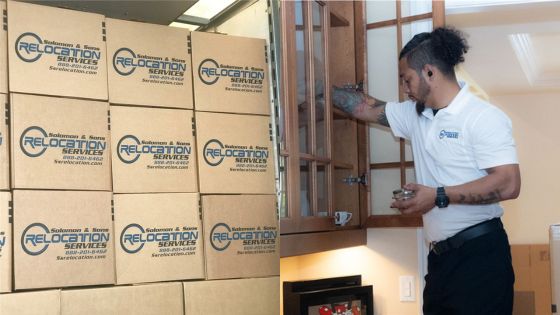 Stacked moving boxes and a professional packing items into a cabinet for relocation services.