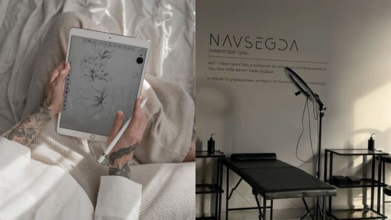 Person sketching floral design on tablet, tattoo studio with tattoo chair and equipment in the background.