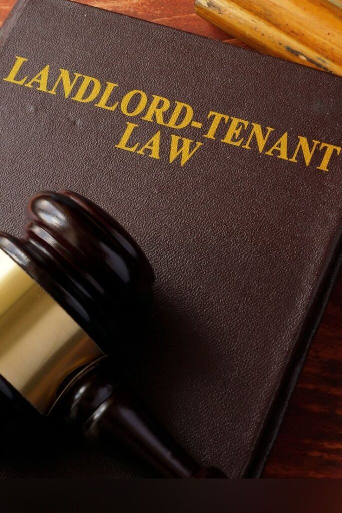 Gavel resting on Landlord-Tenant Law book, symbolizing legal guidance in rental agreements.