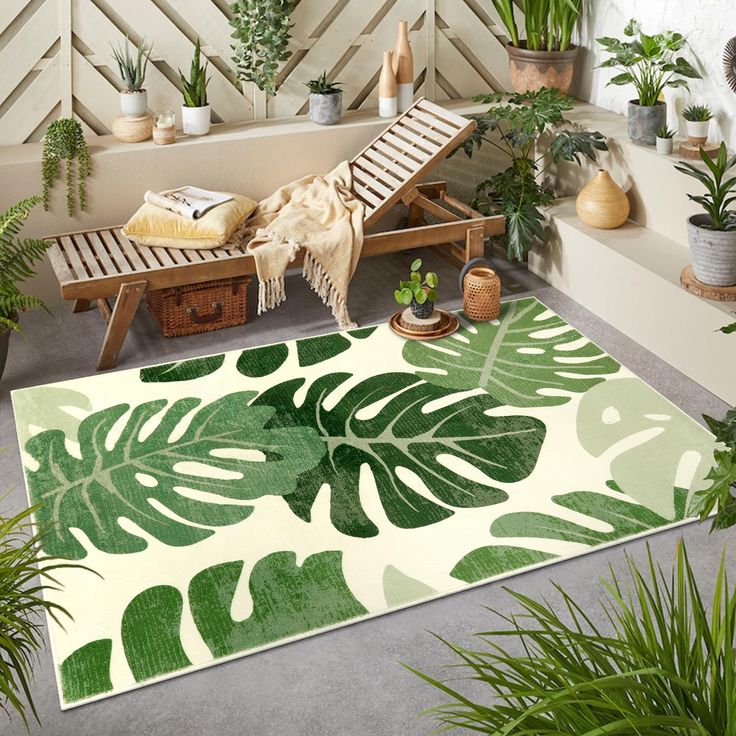 Outdoor patio with tropical leaves rug, wooden lounger, cozy throw, and potted plants for a relaxing garden setting.