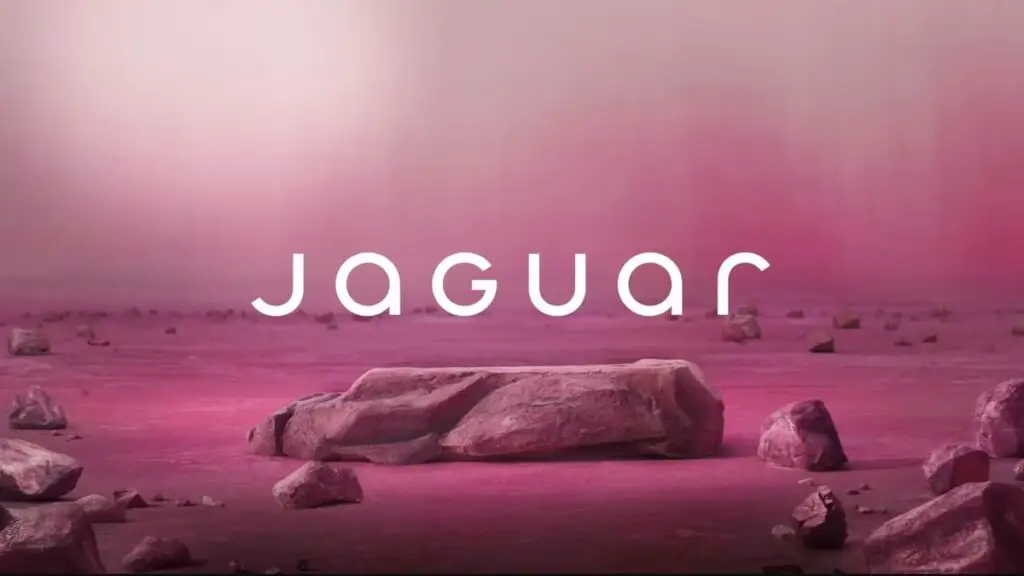 Jaguar logo on a pink rocky landscape background, showcasing a blend of nature and brand identity.