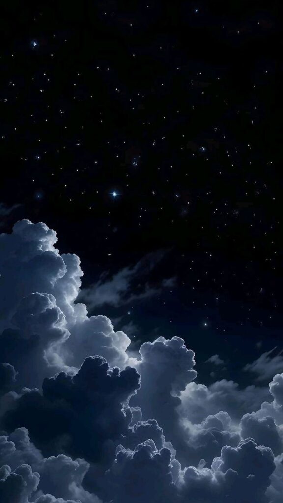 Starry night sky with illuminated clouds under a dark backdrop.