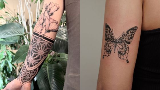 Intricate arm tattoos: geometric floral sleeve on the left, detailed butterfly design on the right.