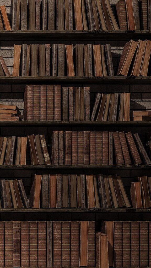 Vintage books neatly arranged on an old wooden bookshelf, conveying a sense of history and knowledge.