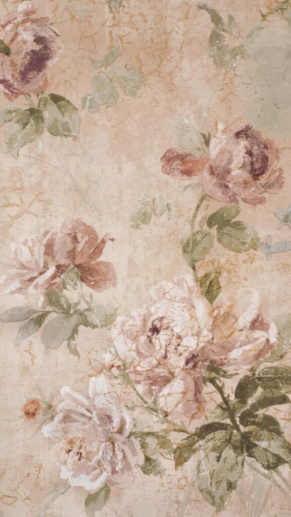 Vintage floral wallpaper with pastel roses and green leaves on a textured beige background.