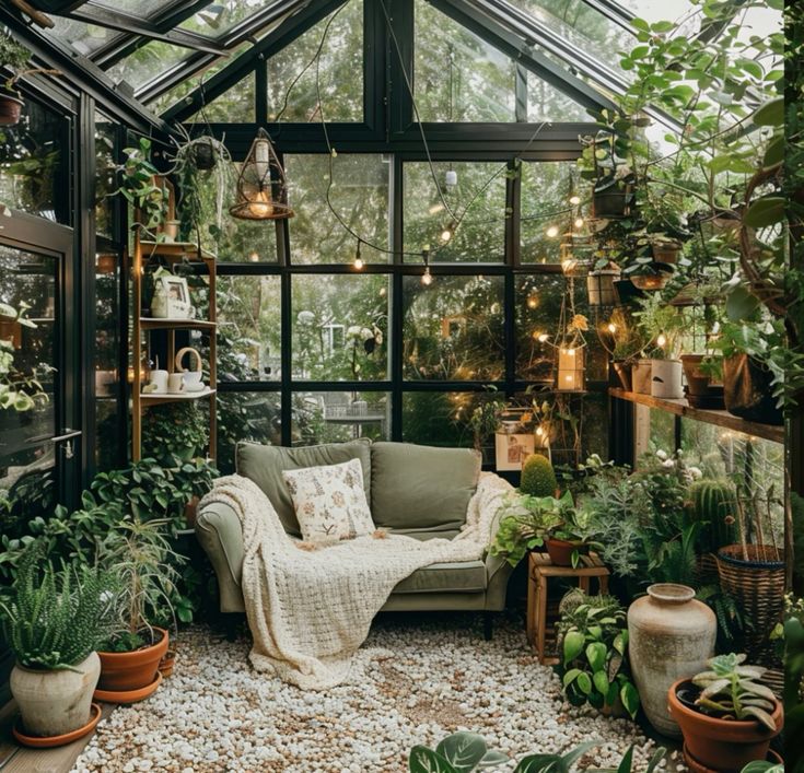 Cozy sunroom with a green sofa, lush plants, string lights, and natural decor, creating a serene indoor garden retreat.