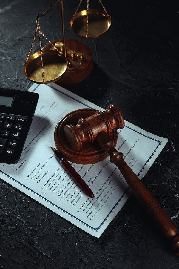 Gavel and scales of justice on legal documents, symbolizing law and justice concepts.