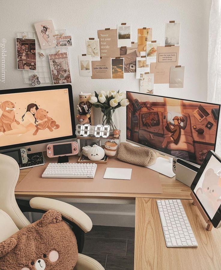 Cozy aesthetic workspace with dual monitors, keyboard, flowers, and wall collage for a creative home office setup.