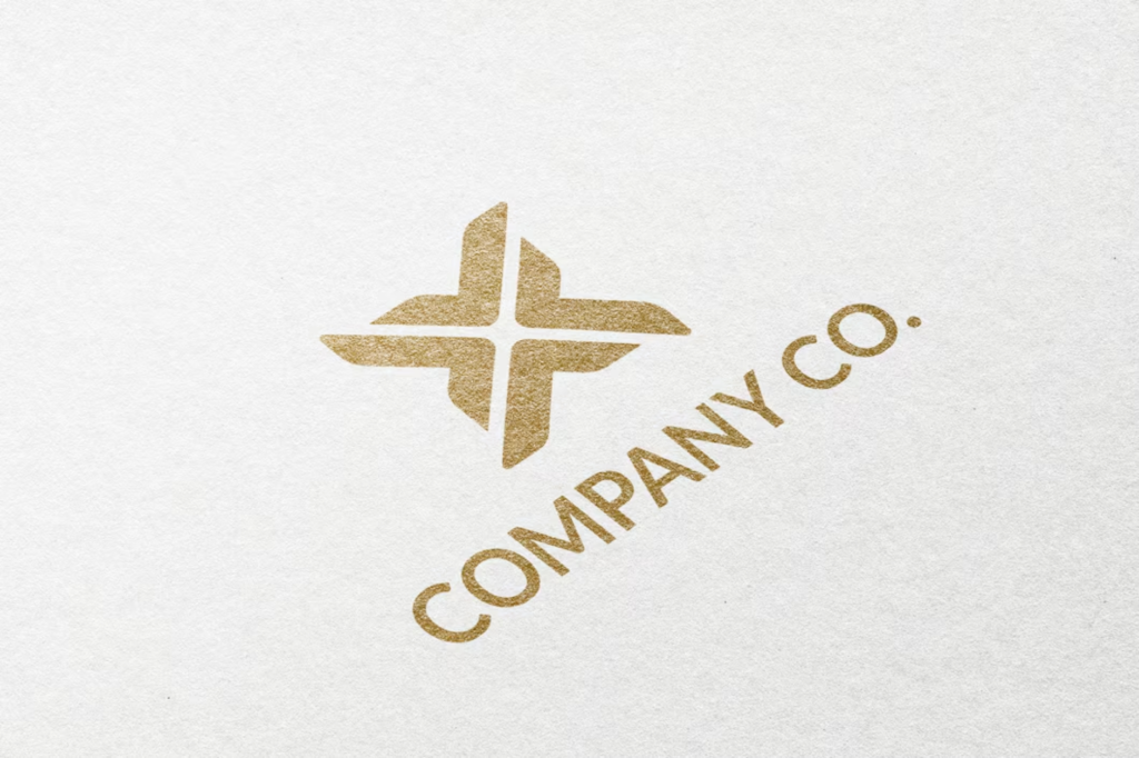 Gold geometric logo for Company Co. on textured white background.