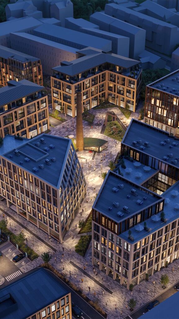 Aerial view of modern urban apartment complex at night, warmly illuminated with people walking on the pathways.