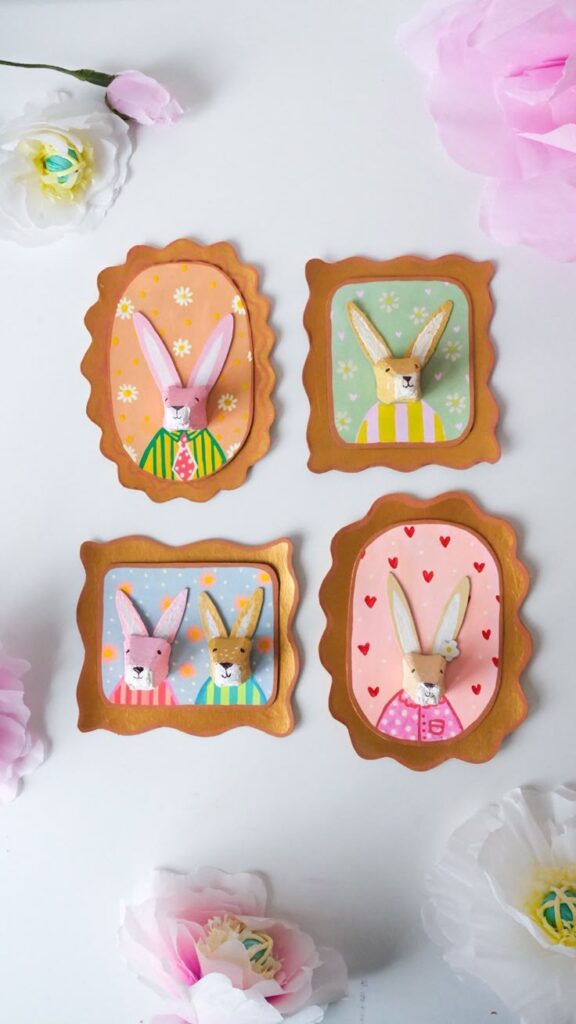 Framed bunny portraits with colorful backgrounds and flowers on a white surface.