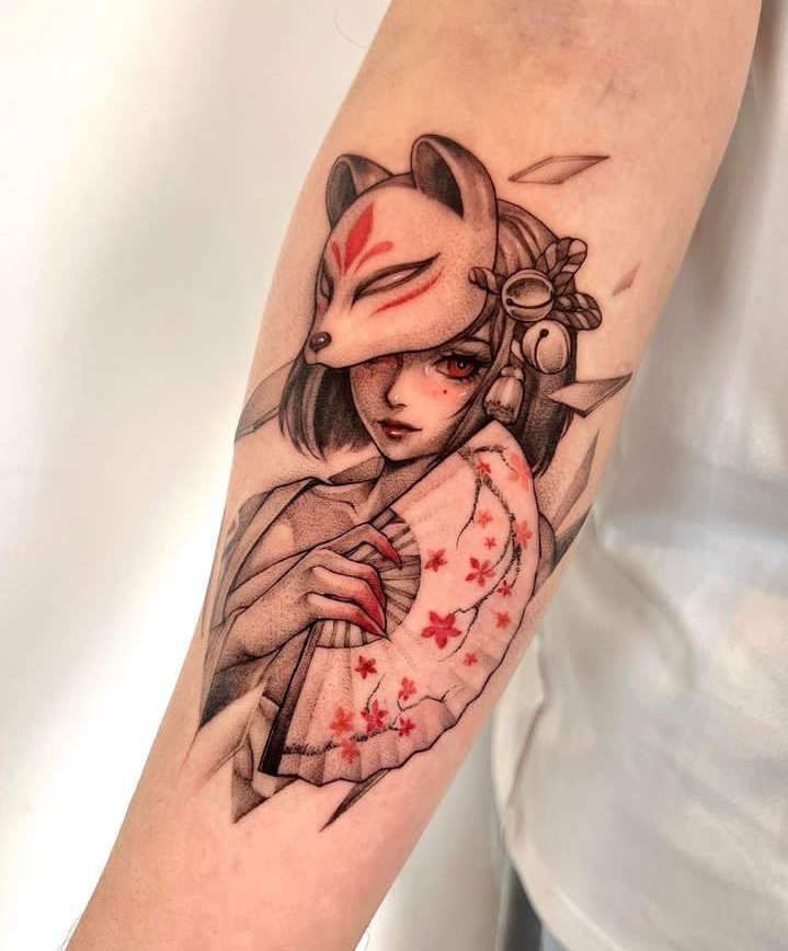 Detailed tattoo of a woman with a fox mask and fan on forearm, vibrant red accents, Japanese art style.