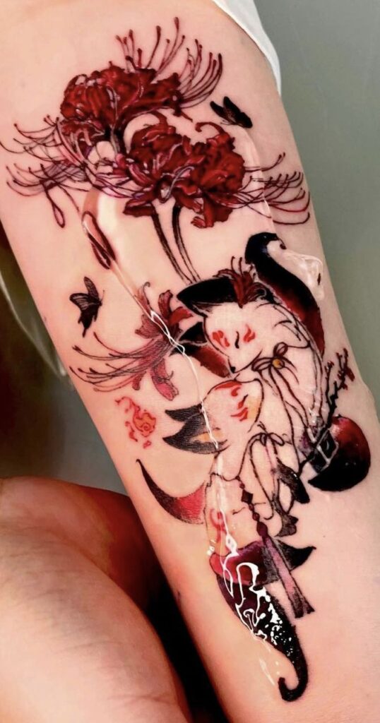 Colorful tattoo of foxes and red flowers on an arm, featuring intricate design and detailed linework.