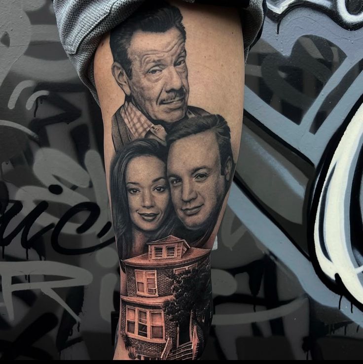 Realistic tattoo on a leg featuring three faces and a house with graffiti-like background art.